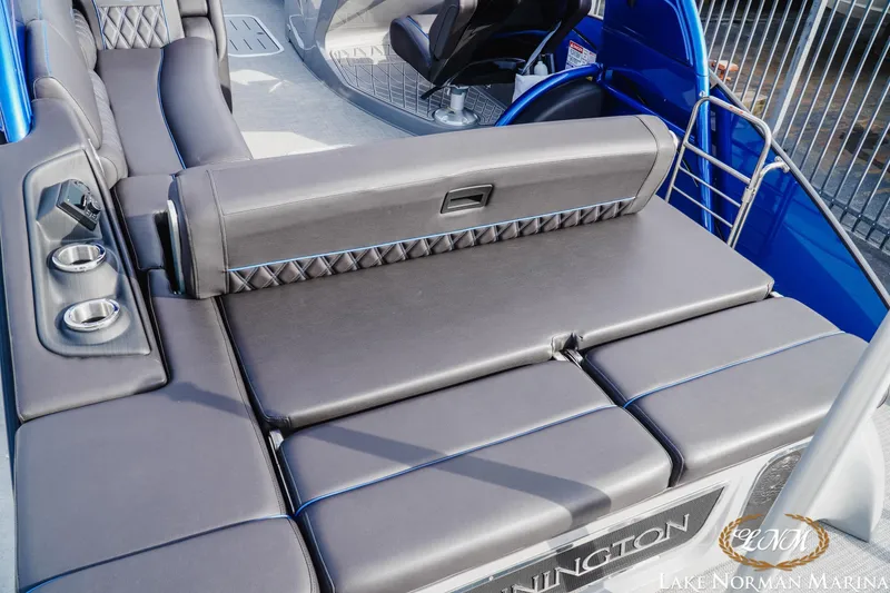 Slide: The Image of 2025 Bennington 25QXSBA boat interior with luxurious seating and cup holders. - 9