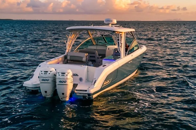 Slide: The Image of 2019 Boston Whaler 320 Vantage boat on open water at sunset. - 10