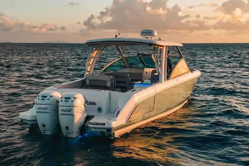 Slide: The Image of 2019 Boston Whaler 320 Vantage boat on water at sunset with twin engines. - 14