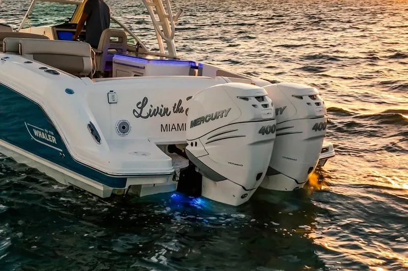 Slide: The Image of 2019 Boston Whaler 320 Vantage with twin Mercury 400 engines on water at sunset. - 16