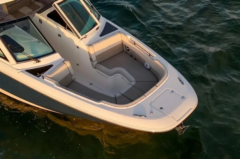 Slide: The Image of 2019 Boston Whaler 320 Vantage boat on water, featuring spacious seating and sleek design. - 18