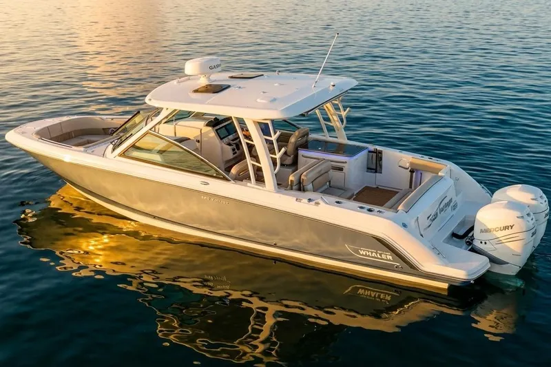 Slide: The Image of 2019 Boston Whaler 320 Vantage boat on calm water at sunset. - 21