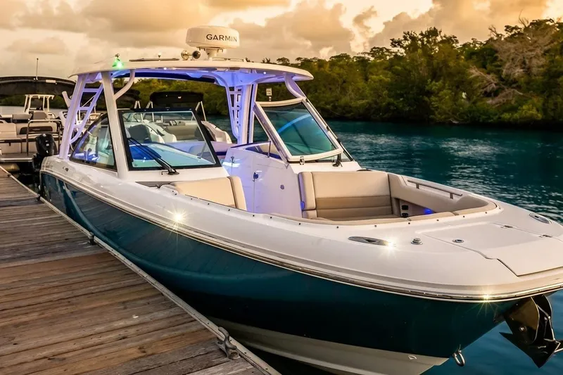 Slide: The Image of 2019 Boston Whaler 320 Vantage boat docked at sunset, featuring sleek design and modern amenities. - 26