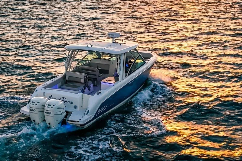 Slide: The Image of 2019 Boston Whaler 320 Vantage cruising at sunset on open water. - 3