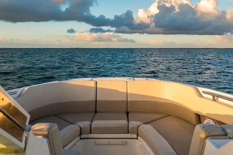 Slide: The Image of 2019 Boston Whaler 320 Vantage boat interior with ocean view and cloudy sky. - 34