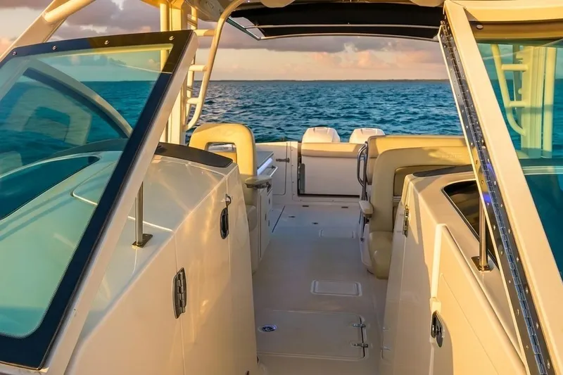 Slide: The Image of 2019 Boston Whaler 320 Vantage boat interior with ocean view at sunset. - 37