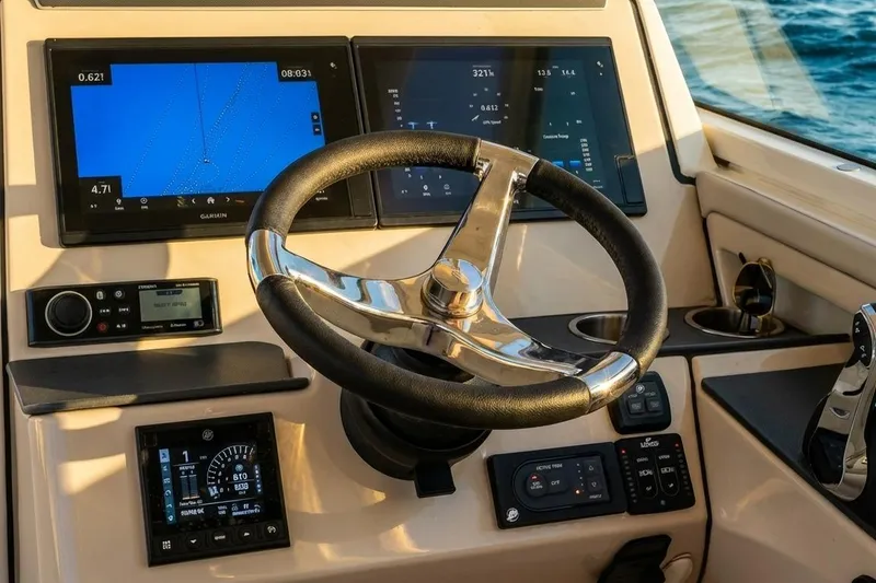 Slide: The Image of 2019 Boston Whaler 320 Vantage helm with modern navigation displays and controls. - 38