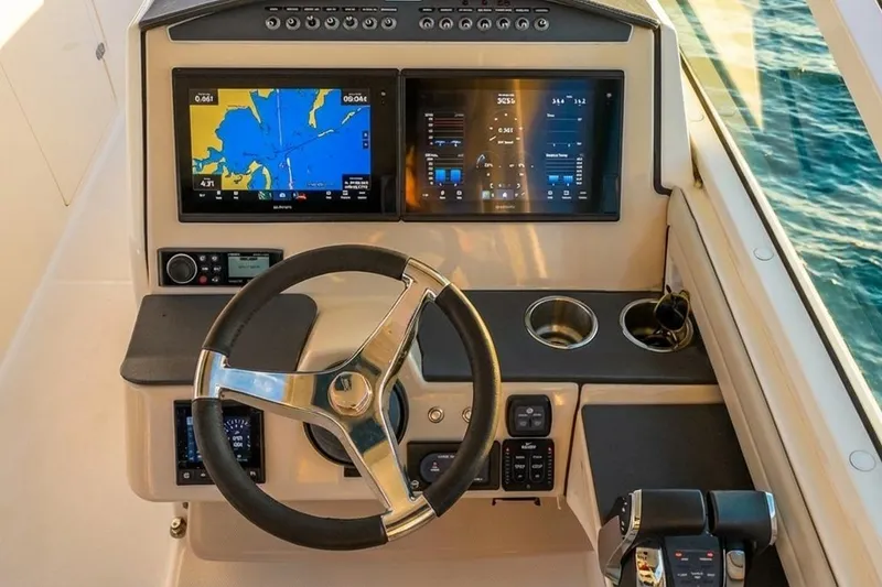 Slide: The Image of 2019 Boston Whaler 320 Vantage helm with dual displays and steering wheel. - 39