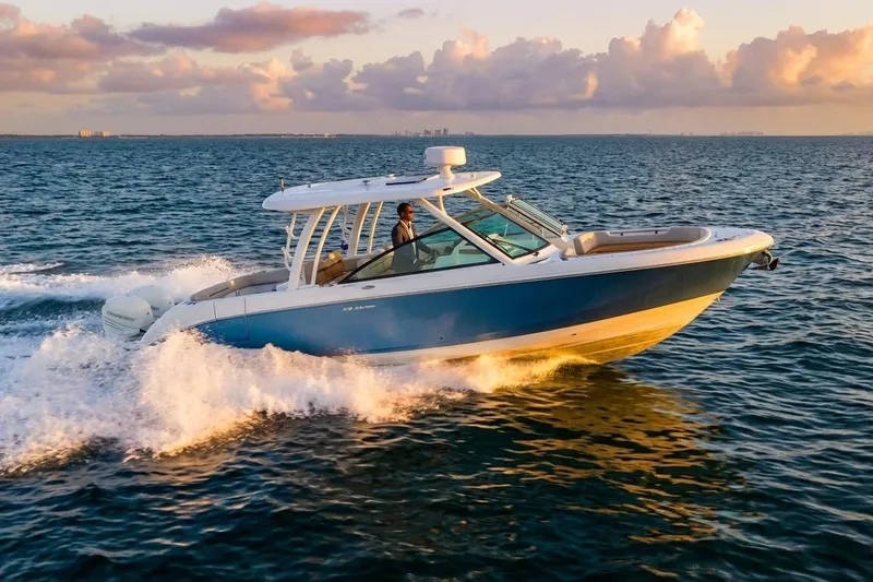 Slide: The Image of 2019 Boston Whaler 320 Vantage cruising on open water at sunset. - 4