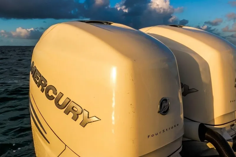Slide: The Image of Twin Mercury outboard engines on a 2019 Boston Whaler 320 Vantage boat at sea. - 43