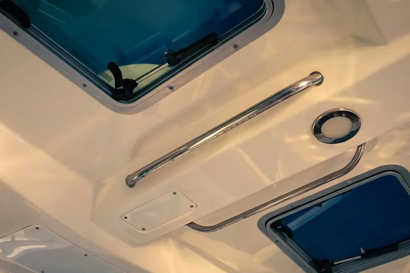 Slide: The Image of Interior view of 2019 Boston Whaler 320 Vantage boat ceiling with windows and handle. - 45