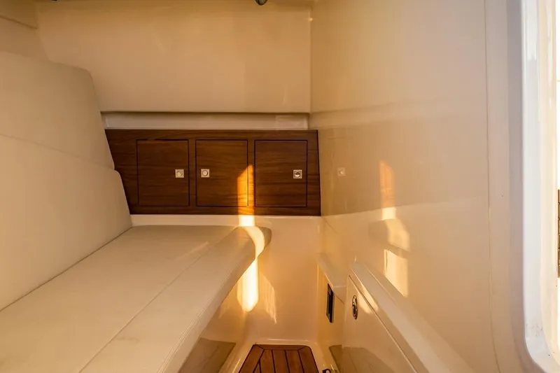 Slide: The Image of Interior cabin of 2019 Boston Whaler 320 Vantage with wooden storage cabinets. - 46