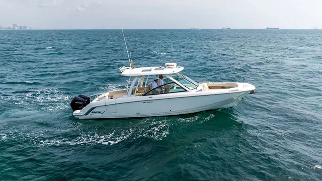 Slide: The Image of 2020 Boston Whaler 320 Vantage boat on open water under blue sky. - 49