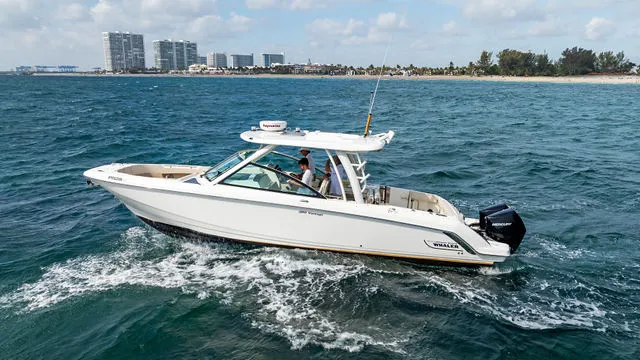Slide: The Image of 2020 Boston Whaler 320 Vantage boat on clear blue ocean water under a sunny sky. - 51