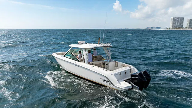 Slide: The Image of 2020 Boston Whaler 320 Vantage boat on open sea with twin engines. - 52