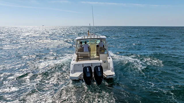 Slide: The Image of 2020 Boston Whaler 320 Vantage docked at a marina with twin engines. - 53