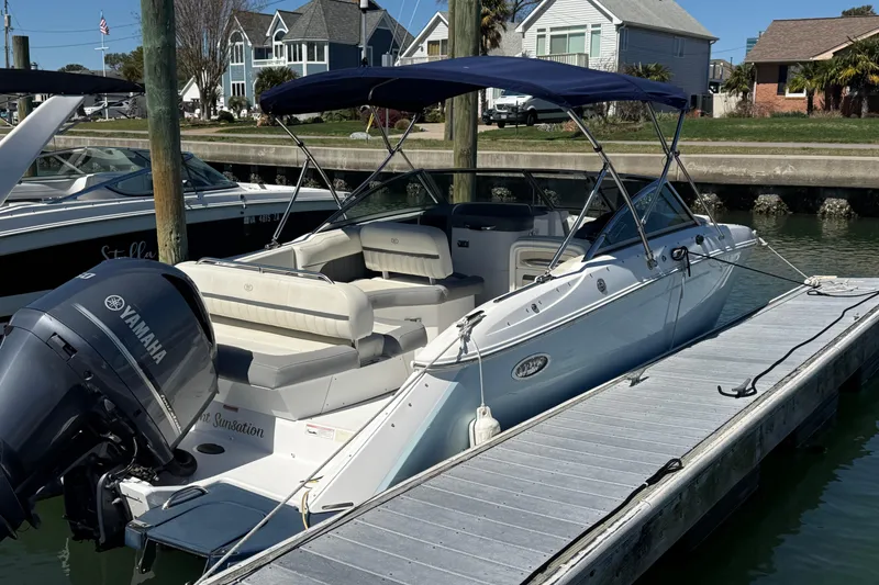 Slide: The Image of 2020 Cobalt CS23 boat docked with Yamaha outboard motor, featuring a blue canopy. - 3