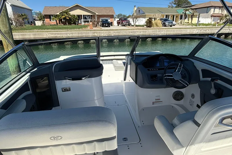 Slide: The Image of Interior view of a 2020 Cobalt CS23 boat, featuring sleek seating and a modern dashboard. - 5