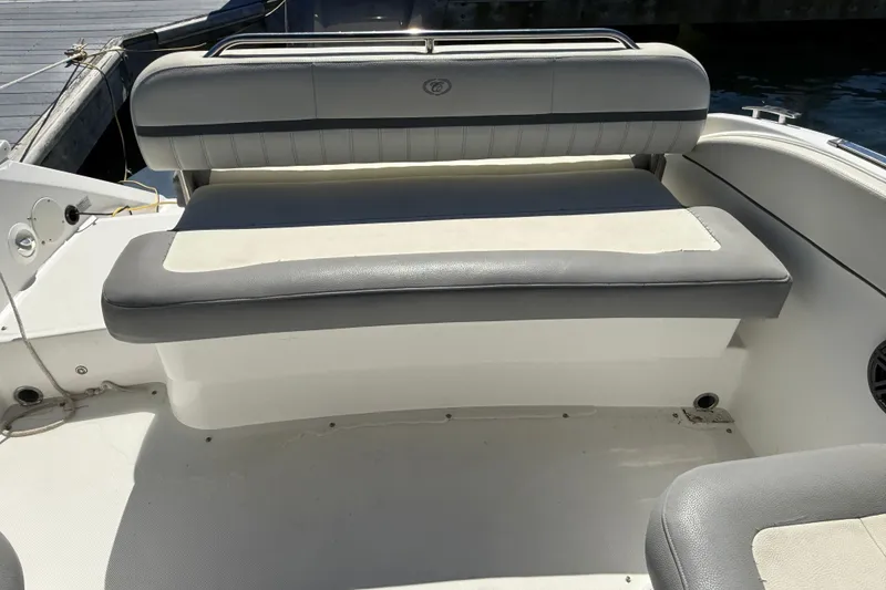 Slide: The Image of 2020 Cobalt CS23 boat interior with gray and white seating at the dock. - 9