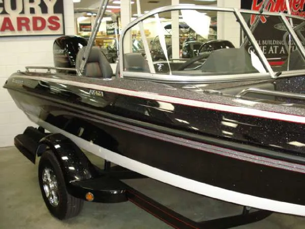 Slide: The Image of 2014 Ranger 1850 LS boat displayed in a showroom. - 11