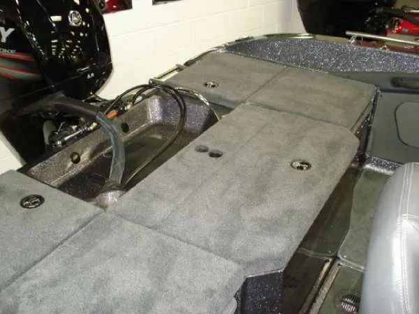 Slide: The Image of Interior of a 2014 Ranger 1850 LS boat with gray carpeting. - 16