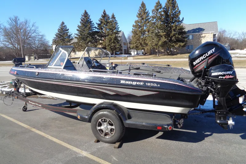 Slide: The Image of 2014 Ranger 1850 LS boat with Mercury engine on trailer, parked outdoors. - 2