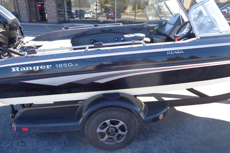 Slide: The Image of 2014 Ranger 1850 LS boat on trailer, parked outside a building. - 31