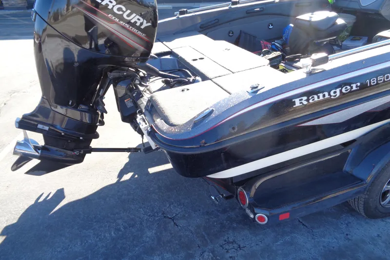 Slide: The Image of 2014 Ranger 1850 LS boat with Mercury FourStroke engine, parked on concrete surface. - 32