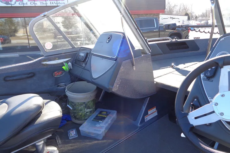 Slide: The Image of Interior of a 2014 Ranger 1850 LS boat with steering wheel and dashboard. - 34