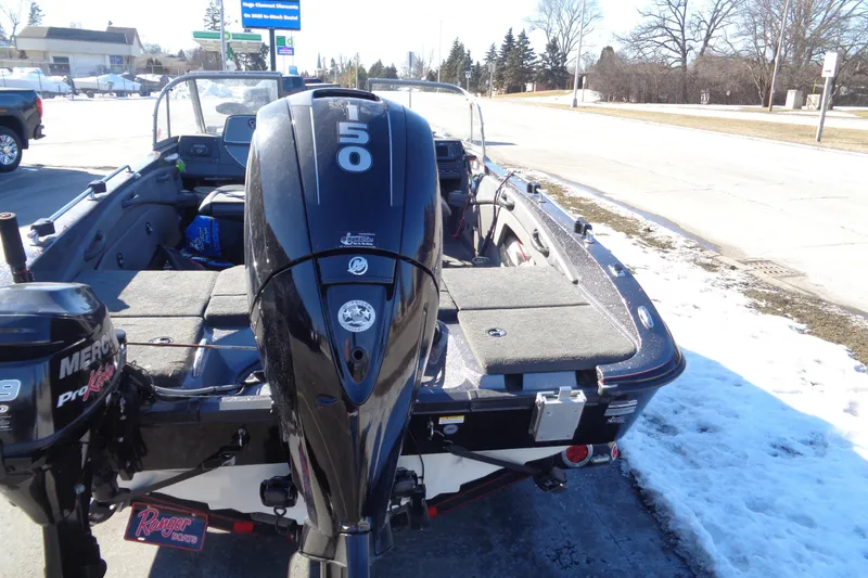 Slide: The Image of 2014 Ranger 1850 LS boat with Mercury outboard motor, parked on snowy roadside. - 35