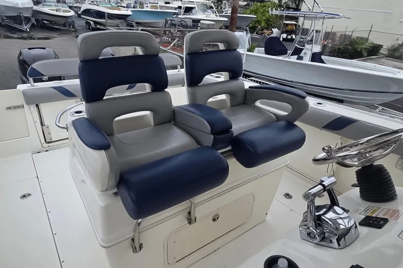 Slide: The Image of 2006 Boston Whaler 320 Outrage Cuddy Cabin with dual cushioned seats and steering console. - 10