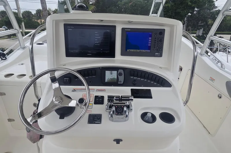 Slide: The Image of Helm of 2006 Boston Whaler 320 Outrage Cuddy Cabin with navigation screens and controls. - 12