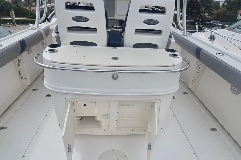 Slide: The Image of 2006 Boston Whaler 320 Outrage Cuddy Cabin interior with open storage compartment. - 15