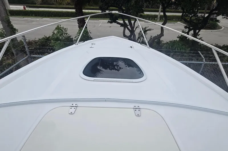 Slide: The Image of 2006 Boston Whaler 320 Outrage Cuddy Cabin boat deck with hatch and railing. - 18