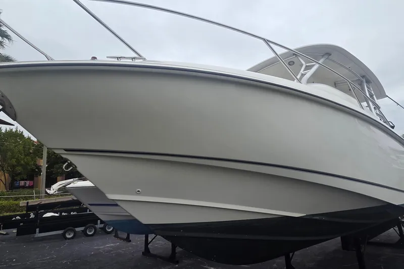 Slide: The Image of 2006 Boston Whaler 320 Outrage Cuddy Cabin boat on display, side view. - 2