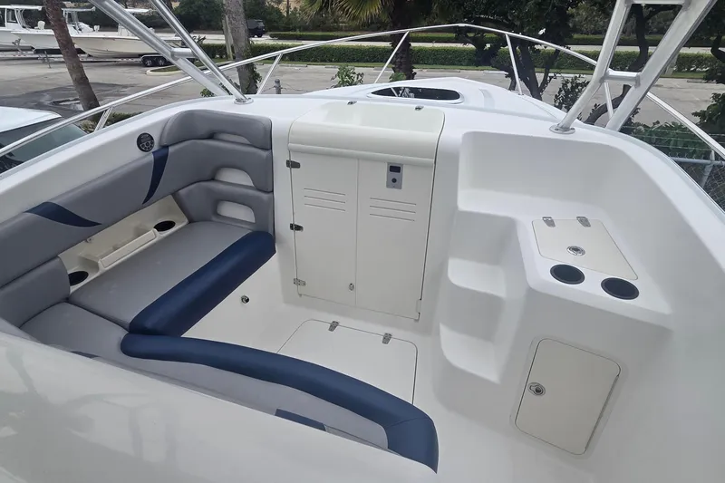 Slide: The Image of 2006 Boston Whaler 320 Outrage Cuddy Cabin interior with seating and storage compartments. - 20