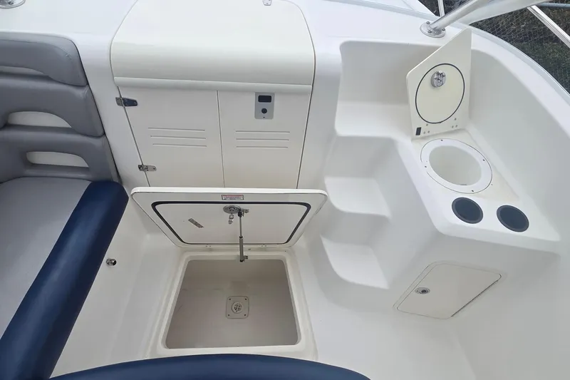 Slide: The Image of 2006 Boston Whaler 320 Outrage Cuddy Cabin interior with storage compartments and seating. - 22