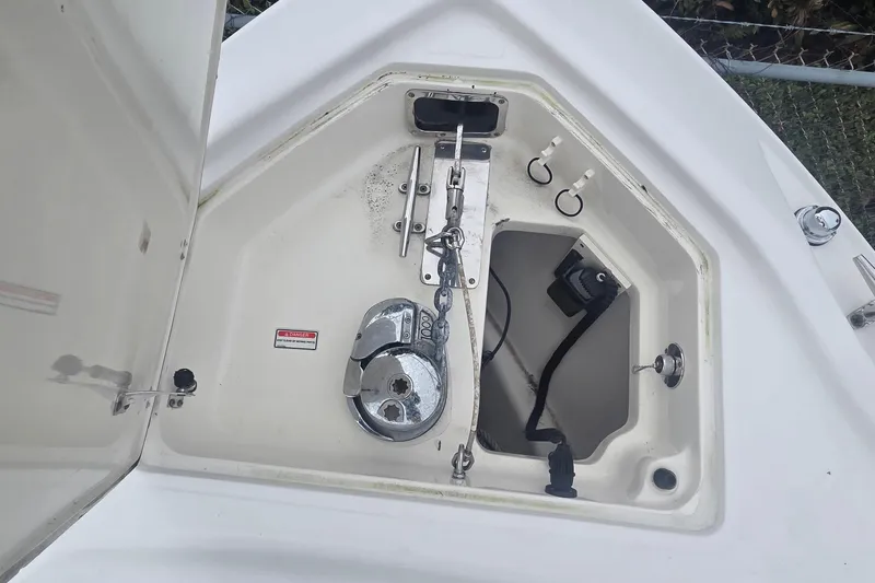 Slide: The Image of Anchor compartment of 2006 Boston Whaler 320 Outrage Cuddy Cabin boat. - 24