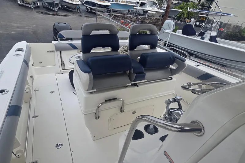 Slide: The Image of 2006 Boston Whaler 320 Outrage Cuddy Cabin with dual seating and steering wheel. - 25
