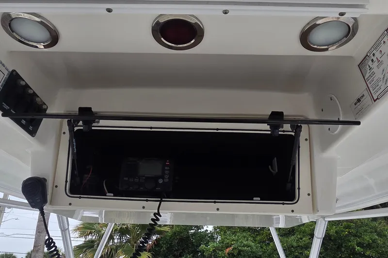 Slide: The Image of 2006 Boston Whaler 320 Outrage Cuddy Cabin electronics compartment with radio and controls. - 4