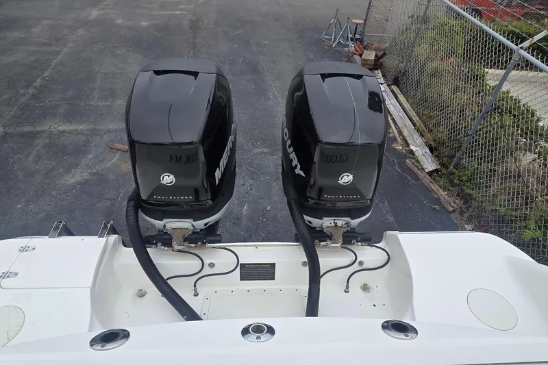 Slide: The Image of Twin Mercury outboard engines on a 2006 Boston Whaler 320 Outrage Cuddy Cabin boat. - 5