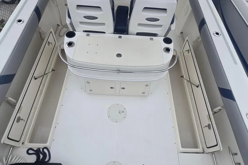 Slide: The Image of 2006 Boston Whaler 320 Outrage Cuddy Cabin interior with seating and storage compartments. - 6
