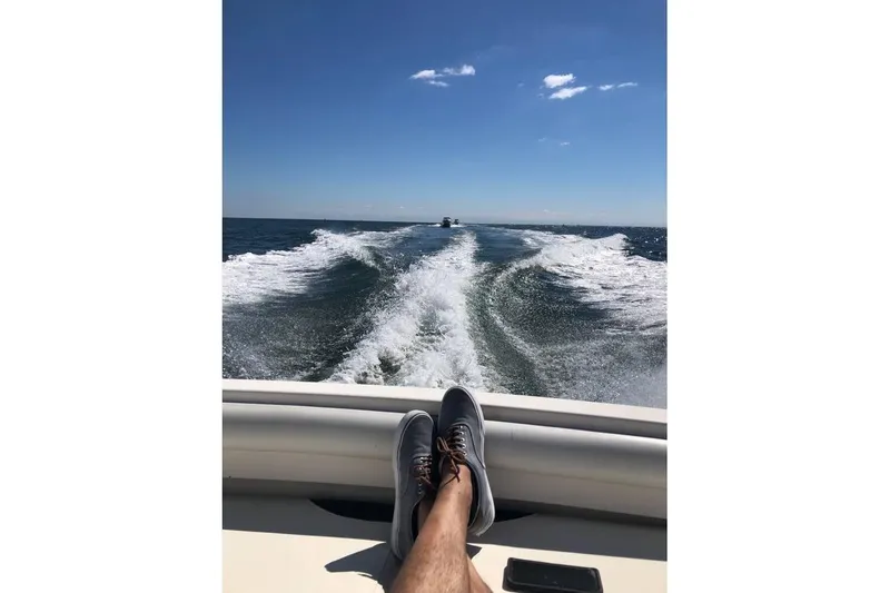 Slide: The Image of Relaxing on a 1999 Wellcraft 330 Coastal boat, enjoying ocean waves and clear skies. - 4