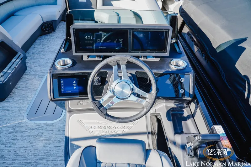 Slide: The Image of 2026 Bennington 24MSB boat dashboard with modern controls and steering wheel at Lake Norman Marina. - 10