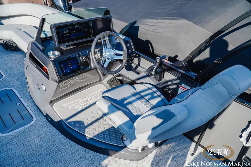 Slide: The Image of 2026 Bennington 24MSB boat helm with modern controls and comfortable seating at Lake Norman Marina. - 9