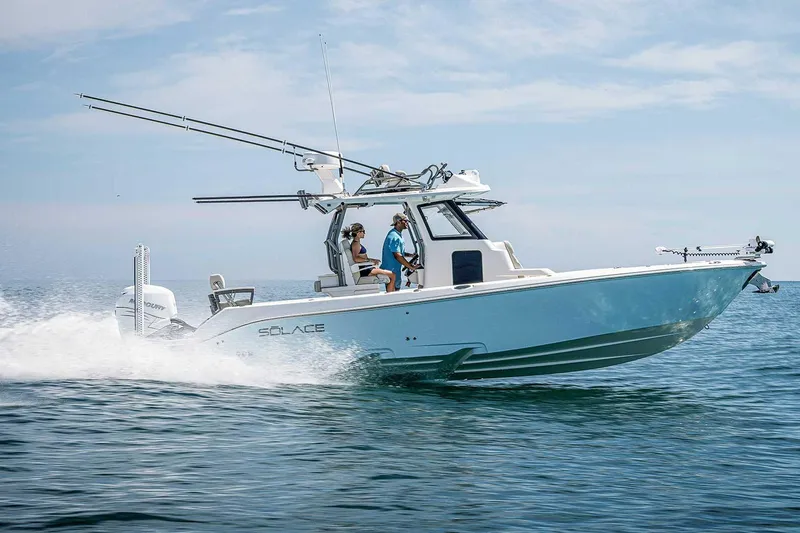The Image of Manufacturer Provided Image: 2026 Solace 30 HCS boat cruising on open water under clear skies. - 0