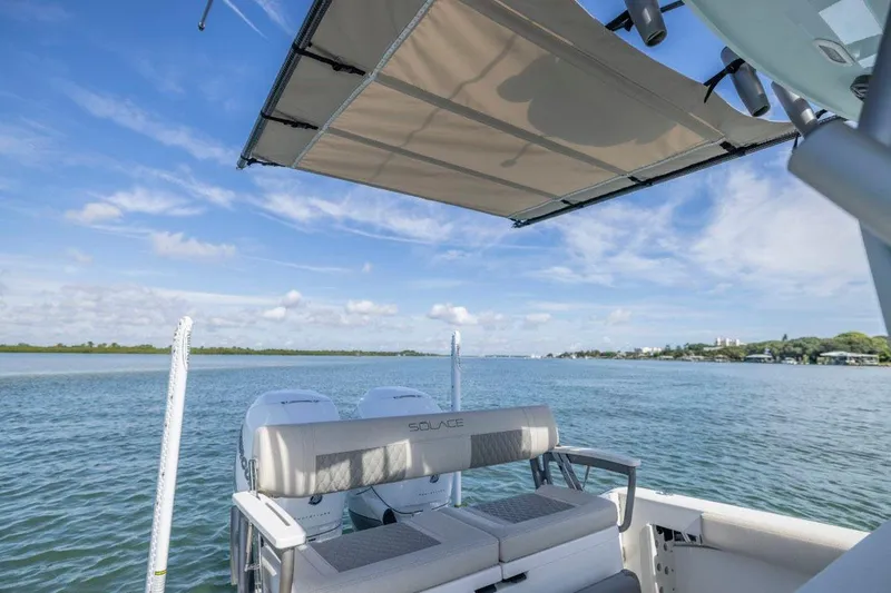 Slide: The Image of Manufacturer Provided Image: 2026 Solace 30 HCS boat with canopy, dual engines, and scenic water view. - 9