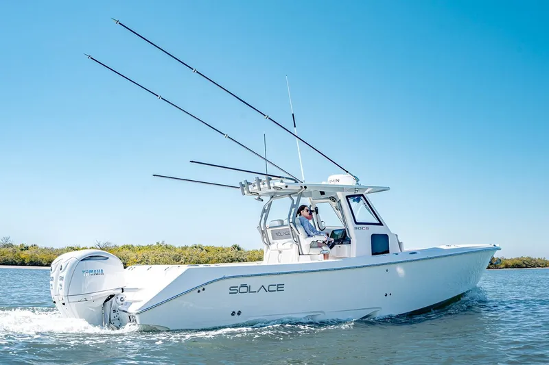 Slide: The Image of Manufacturer Provided Image: 2026 Solace 30 CS boat cruising on water with fishing rods and Yamaha engine. - 2