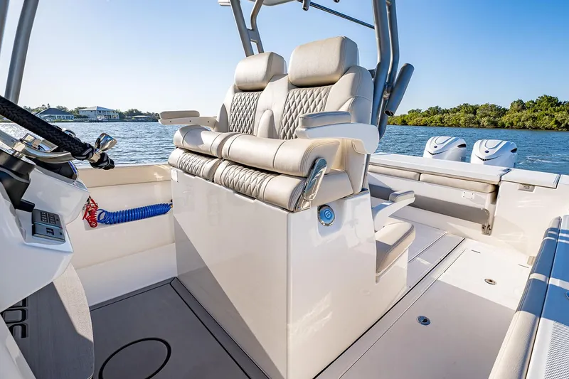 Slide: The Image of Manufacturer Provided Image: 2026 Solace 30 CS boat interior with luxurious seating and dual engines on a sunny day. - 4
