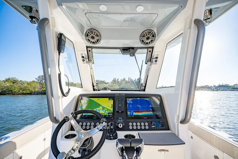 Slide: The Image of Manufacturer Provided Image: Interior view of 2026 Solace 30 CS boat cockpit with advanced navigation system. - 5